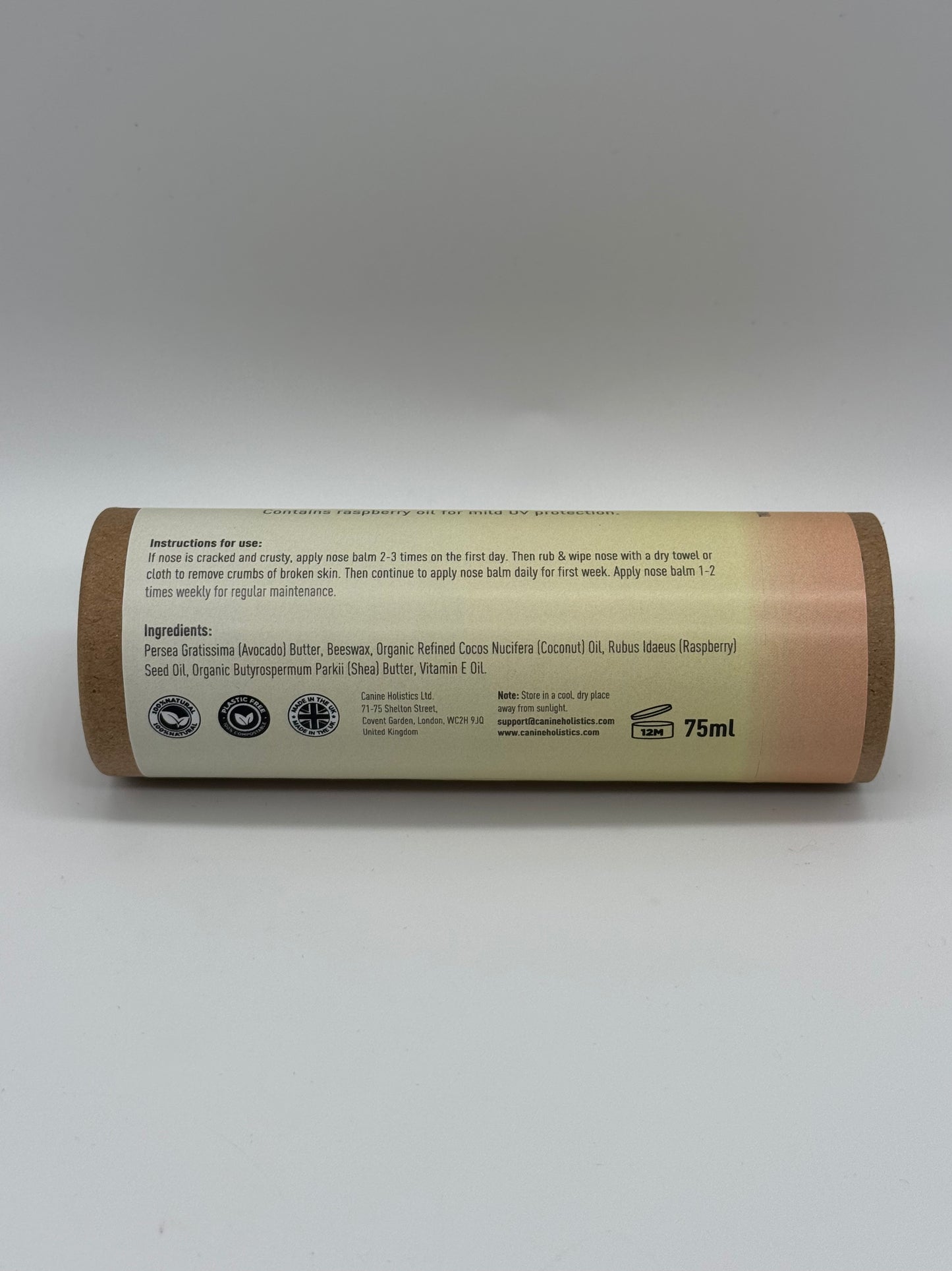Canine Holistics™ Natural Nose Balm for Dogs 100ml. Rear view of branded product in biodegradable tube laying on its side, displaying product ingredients and instructions for use.