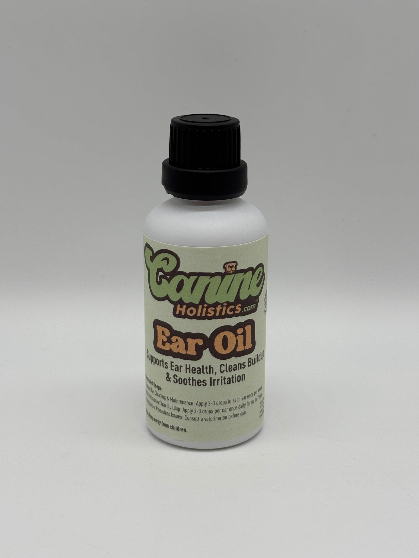 Image of Canine Holistics™ natural ear oil for dogs in a white glass bottle with dripper nozzle and a black lid. Front view of branded product. 