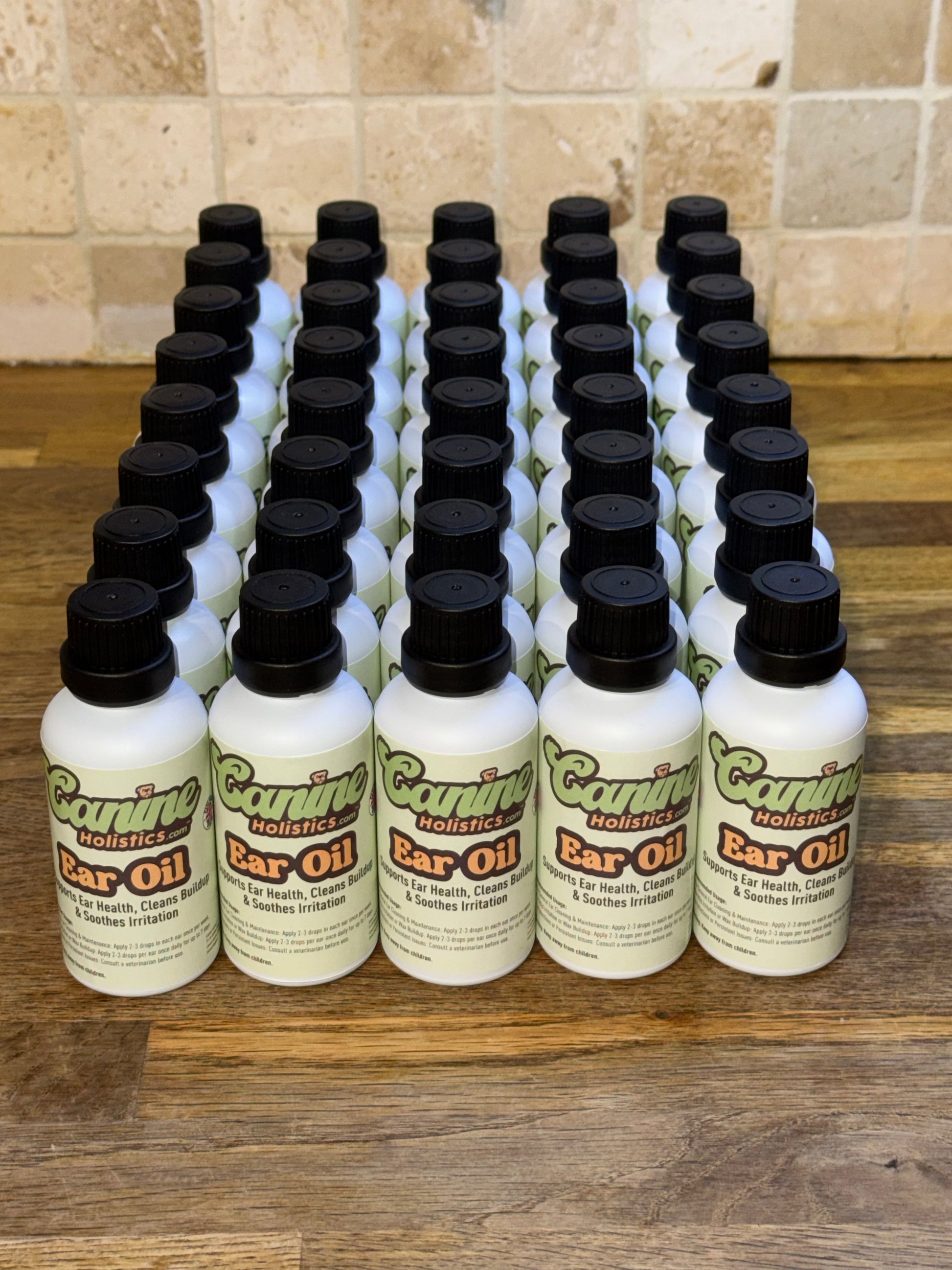 Image of Canine Holistics™ natural ear oil for dogs in white glass bottles. Top front view of 40 bottles neatly organised. 