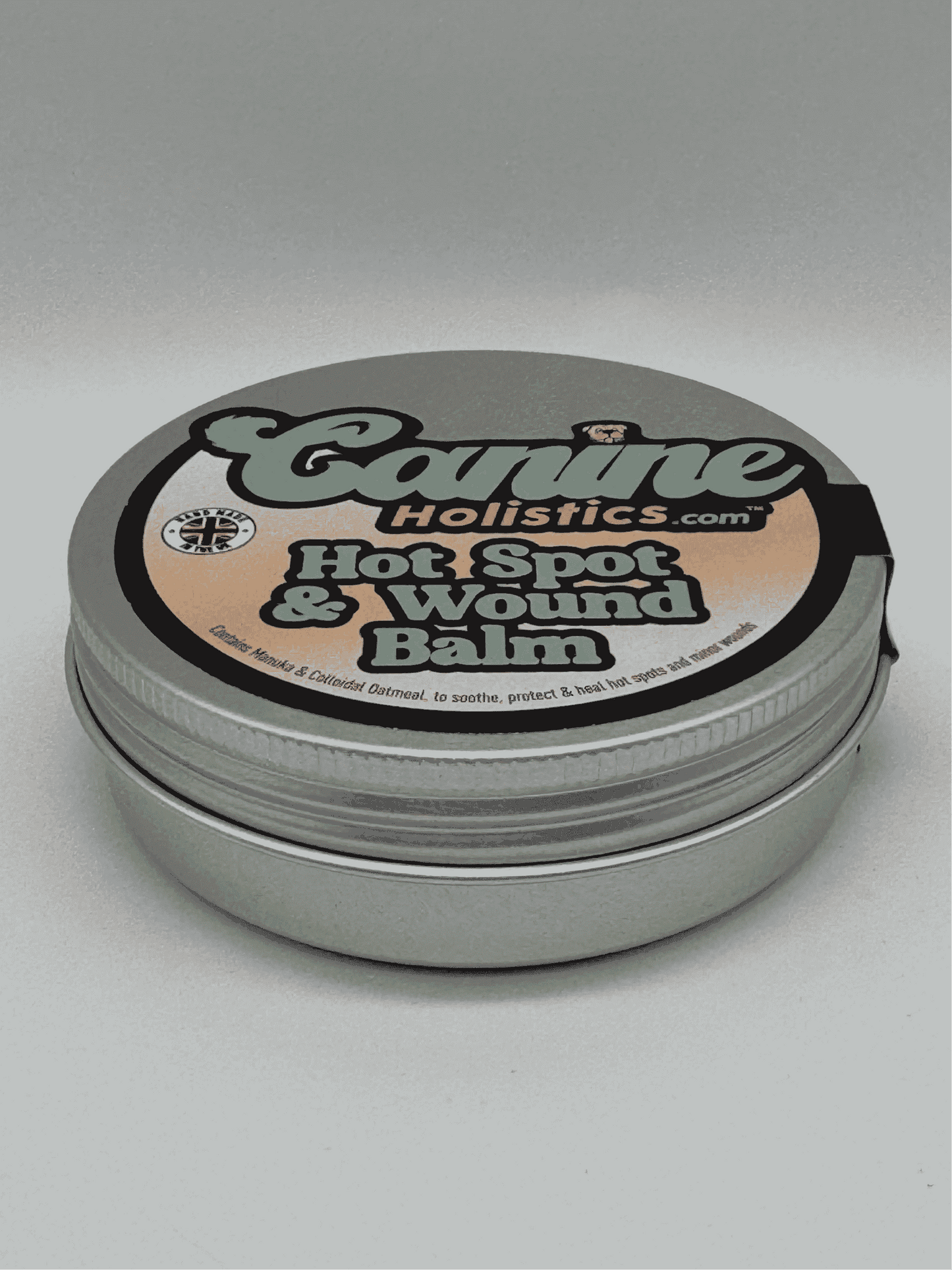 Image of Canine Holistics™ Hot Spot and Wound Balm 100ml tin. Top front view of branded packaging. 