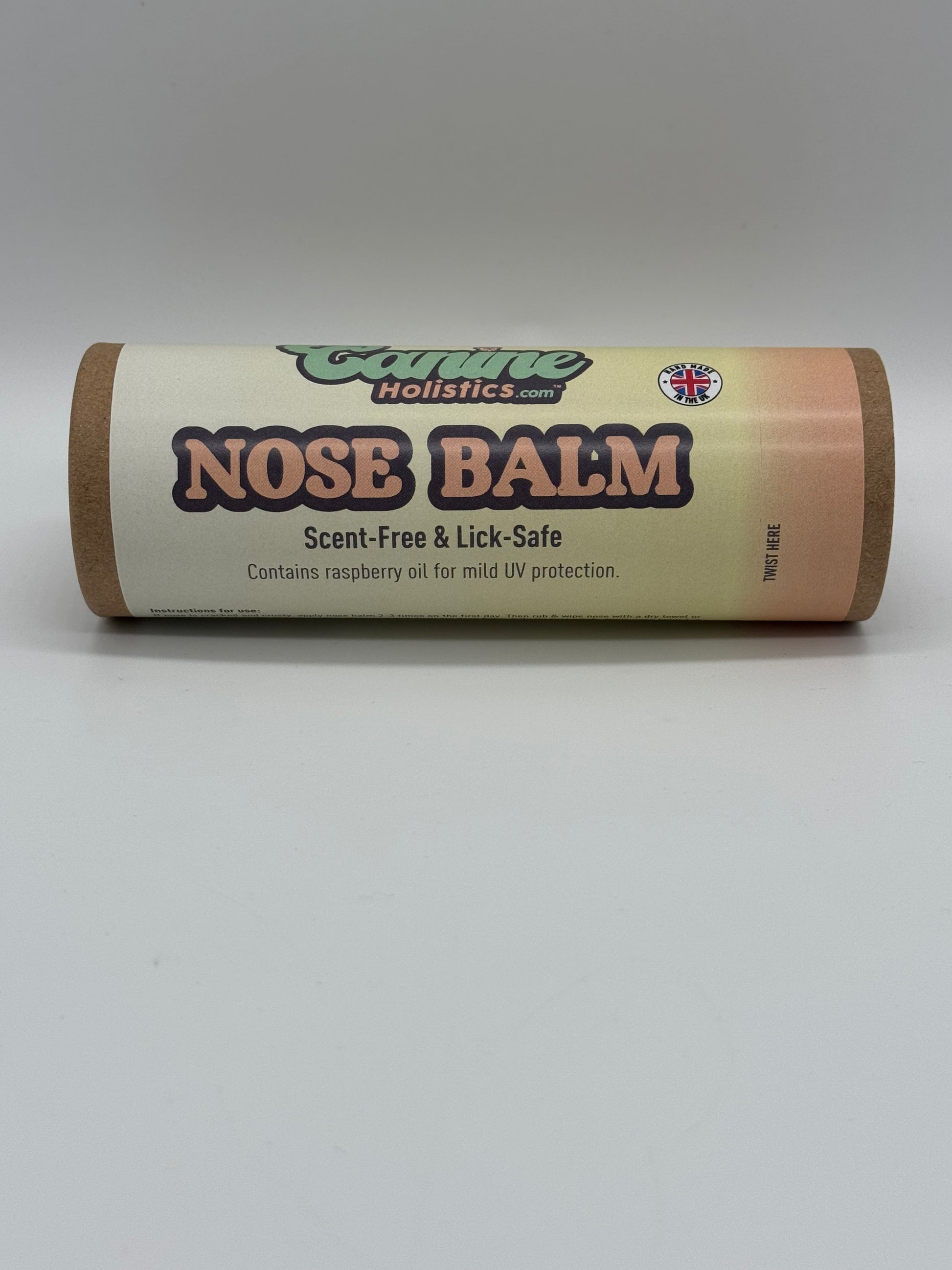 Image containing Canine Holistics™ Natural Nose Balm for Dogs 100ml. Front view of branded product in biodegradable tube laying on its side. 